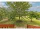 Picture perfect backyard with a mature tree, lush lawn, and a stairway leading to a deck at 6024 Highview Rd, Weddington, NC 28104
