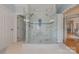 Glass-enclosed walk-in shower features elegant tile work and updated shower head at 6024 Highview Rd, Weddington, NC 28104