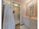 Well-lit bathroom boasts a framed mirror, modern vanity, and attached bathroom with shower/tub at 6024 Highview Rd, Weddington, NC 28104