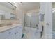 Bright bathroom features tile floor, white vanity, tile shower, and extra cabinet space at 6024 Highview Rd, Weddington, NC 28104