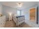 Bright bedroom with soft blue walls, neutral carpet, ceiling fan, and attached bathroom at 6024 Highview Rd, Weddington, NC 28104