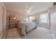 Comfortable bedroom features neutral carpet, ceiling fan, decorative rug and furniture and bright natural light at 6024 Highview Rd, Weddington, NC 28104