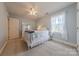 Bright bedroom with soft blue walls, neutral carpet, ceiling fan, and large window at 6024 Highview Rd, Weddington, NC 28104
