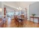Dining room with hardwood floors, and decorative lighting, with an open view to the living room at 6024 Highview Rd, Weddington, NC 28104