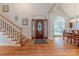 Bright foyer with hardwood floors, staircase, and decorative front door creates a welcoming entry at 6024 Highview Rd, Weddington, NC 28104