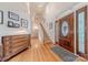 Stately foyer features hardwood floors, a grand staircase, and elegant front door at 6024 Highview Rd, Weddington, NC 28104