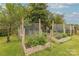 Home garden area featuring raised garden beds with a variety of healthy plants and protective netting at 6024 Highview Rd, Weddington, NC 28104