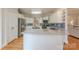 Bright kitchen with white cabinets, stainless steel appliances, and blue backsplash at 6024 Highview Rd, Weddington, NC 28104