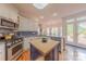Bright kitchen with an island, stainless steel appliances, and adjacent breakfast nook at 6024 Highview Rd, Weddington, NC 28104