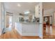 Kitchen featuring granite counters, white cabinets, and hardwood floors at 6024 Highview Rd, Weddington, NC 28104