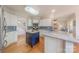 Well-lit kitchen featuring white cabinetry, a blue island, and stainless steel appliances at 6024 Highview Rd, Weddington, NC 28104