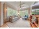 Sunroom with ample windows, bright furnishings, a ceiling fan, and hardwood floors at 6024 Highview Rd, Weddington, NC 28104