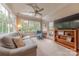 Bright living room features large windows, stylish furnishings, a ceiling fan, and TV at 6024 Highview Rd, Weddington, NC 28104