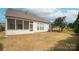 The backyard features a screen porch area, a well-maintained yard, and mature trees at 6310 Highland Commons Rd, Charlotte, NC 28269