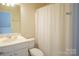 The bathroom features a single sink vanity, toilet, and shower with neutral-colored curtain at 6310 Highland Commons Rd, Charlotte, NC 28269