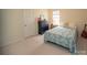 Cozy bedroom with blue paisley bedding, black dresser, and guitar creating a warm atmosphere at 6310 Highland Commons Rd, Charlotte, NC 28269