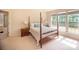 Bright main bedroom with a four-poster bed, hardwood floors, and two large windows at 6310 Highland Commons Rd, Charlotte, NC 28269
