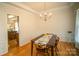 Dining room featuring hardwood floors, a chandelier, and decorative wall trim at 6310 Highland Commons Rd, Charlotte, NC 28269