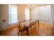 Charming dining room with hardwood floors, a chandelier, and large windows providing ample natural light at 6310 Highland Commons Rd, Charlotte, NC 28269