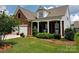 Charming brick home with a covered front porch, well-maintained lawn, and two-car garage at 6310 Highland Commons Rd, Charlotte, NC 28269