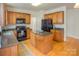 Spacious kitchen featuring wooden cabinetry, granite countertops, a center island, and stainless steel appliances at 6310 Highland Commons Rd, Charlotte, NC 28269