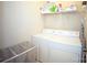 Functional laundry room with a washer, dryer, storage shelves, and a clothes hamper at 6310 Highland Commons Rd, Charlotte, NC 28269