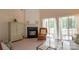 Cozy living room featuring a fireplace, sliding glass doors, and comfortable seating at 6310 Highland Commons Rd, Charlotte, NC 28269