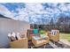 Inviting back patio features comfortable seating, a glass table, and a scenic view, ideal for outdoor entertaining at 7108 Hodges Meadow Ln, Charlotte, NC 28213