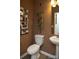 Compact powder room features a pedestal sink, toilet, and stylish decor, ideal for guests at 7108 Hodges Meadow Ln, Charlotte, NC 28213