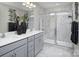 Elegant bathroom with marble finishes, double sinks, and a glass-enclosed shower, offering a spa-like experience at 7108 Hodges Meadow Ln, Charlotte, NC 28213