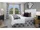 Stylish bedroom featuring a large window, neutral tones, and modern furnishings, creating a relaxing ambiance at 7108 Hodges Meadow Ln, Charlotte, NC 28213