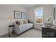 Comfortable bedroom with large window, daybed and neutral decor at 7122 Westrow Ave # 39, Charlotte, NC 27278