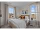 Cozy bedroom featuring a woven wood bed frame, two windows, neutral tones, and stylish decor at 7122 Westrow Ave # 39, Charlotte, NC 27278