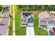Aerial view of a home featuring solar panels, a lawn, and a paved driveway at 7205 Finnigan Rd, Charlotte, NC 28215
