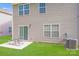Spacious backyard with sliding glass door, patio, and well-maintained lawn and landscaping at 7205 Finnigan Rd, Charlotte, NC 28215