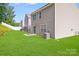 Well-maintained backyard with lush lawn, patio area, and view of neighboring homes at 7205 Finnigan Rd, Charlotte, NC 28215