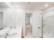 Bright bathroom with dual sink vanity, neutral color palette and an open door to the bedroom at 7205 Finnigan Rd, Charlotte, NC 28215
