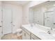 Bright bathroom with dual sink vanity, neutral color palette, and a glass-enclosed shower at 7205 Finnigan Rd, Charlotte, NC 28215