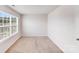 Neutral bedroom featuring a window and closet door at 7205 Finnigan Rd, Charlotte, NC 28215