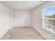 Spacious bedroom featuring neutral walls, carpet, closet and a large window at 7205 Finnigan Rd, Charlotte, NC 28215