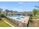 Community pool with seating, shade structures, and a splash pad, perfect for hot summer days at 7205 Finnigan Rd, Charlotte, NC 28215
