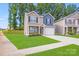 Charming two-story home featuring a manicured lawn and a welcoming two-car garage at 7205 Finnigan Rd, Charlotte, NC 28215