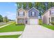 Charming two-story home featuring a manicured lawn and a welcoming two-car garage at 7205 Finnigan Rd, Charlotte, NC 28215