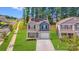 Two-story home with a lush green lawn and trees, solar panels, and a paved driveway at 7205 Finnigan Rd, Charlotte, NC 28215
