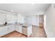 A bright kitchen with stainless steel appliances, granite countertops, and hardwood floors at 7205 Finnigan Rd, Charlotte, NC 28215