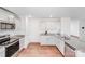 This kitchen has stainless steel appliances, granite countertops and wood flooring at 7205 Finnigan Rd, Charlotte, NC 28215