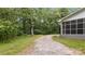 Gravel driveway leading to the backyard, surrounded by lush trees and greenery at 7860 Henry Harris Rd, Fort Mill, SC 29707