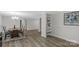 Dining room with hardwood flooring, seating for four at a wooden table, and seamlessly connected to the living room at 7860 Henry Harris Rd, Fort Mill, SC 29707