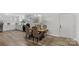 Dining room with a wooden table, seating for four, chandelier, and light pouring through the large window at 7860 Henry Harris Rd, Fort Mill, SC 29707