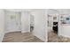 Inviting foyer with stylish wood flooring, light gray walls, and natural light coming in the glass paneled front door at 7860 Henry Harris Rd, Fort Mill, SC 29707